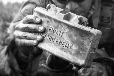 A soldier of the 2nd Armored Cavalry Regiment emplacing an M18 claymore mine